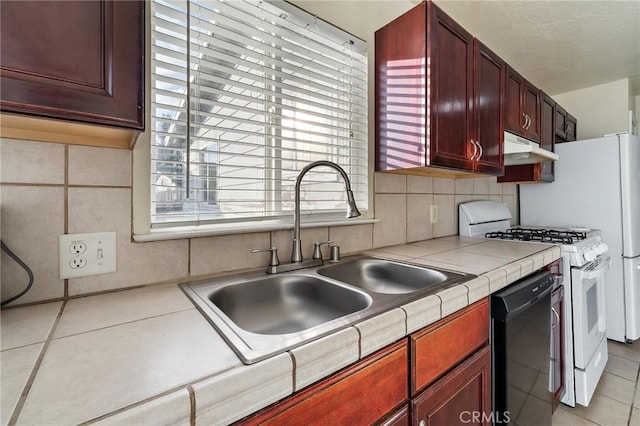 kitchen with dishwasher, backsplash, sink, light tile patterned floors, and gas range gas stove