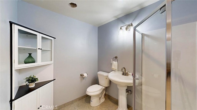 bathroom featuring toilet, walk in shower, and sink