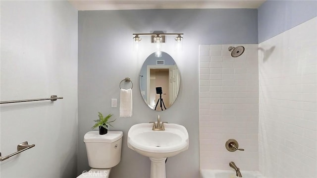 full bathroom with sink, toilet, and tiled shower / bath