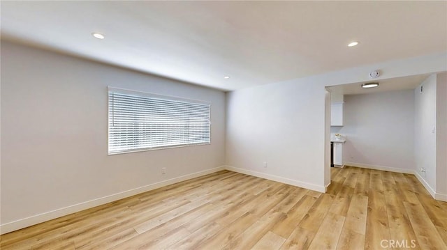 spare room featuring light wood-type flooring