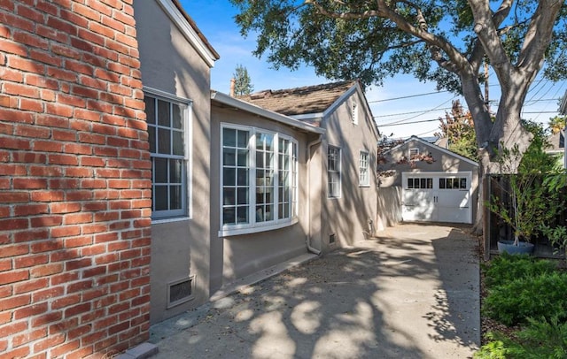 view of side of property with a garage and an outdoor structure