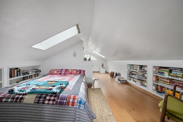 bedroom with vaulted ceiling and light wood-type flooring