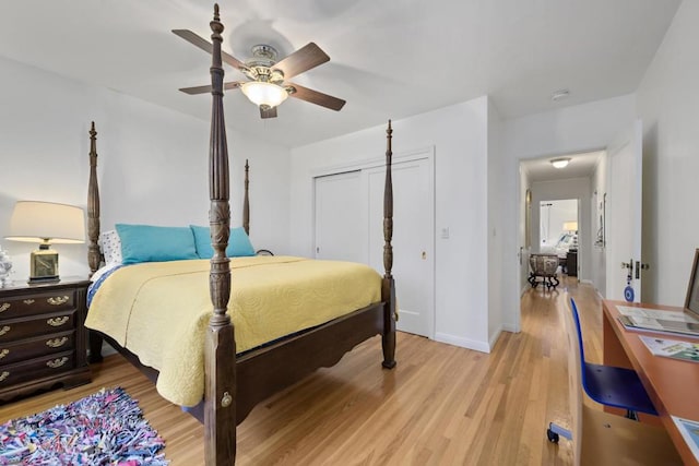 bedroom featuring light hardwood / wood-style flooring, ceiling fan, and a closet