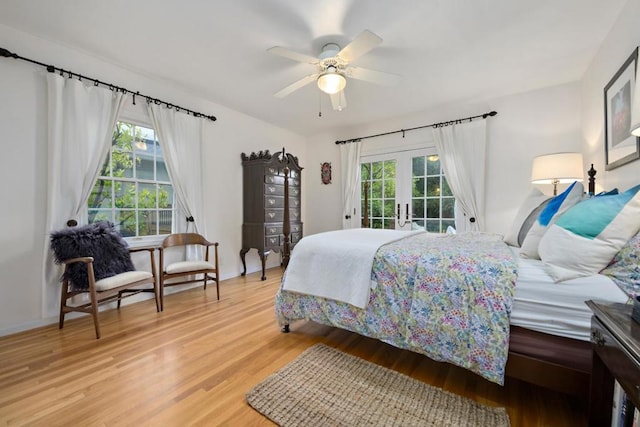 bedroom featuring hardwood / wood-style floors, access to outside, french doors, and ceiling fan