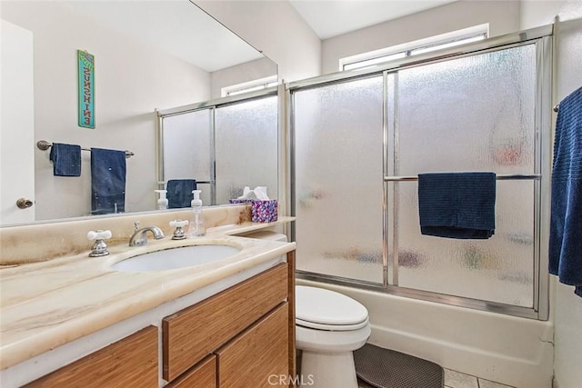 full bathroom featuring vanity, shower / bath combination with glass door, and toilet