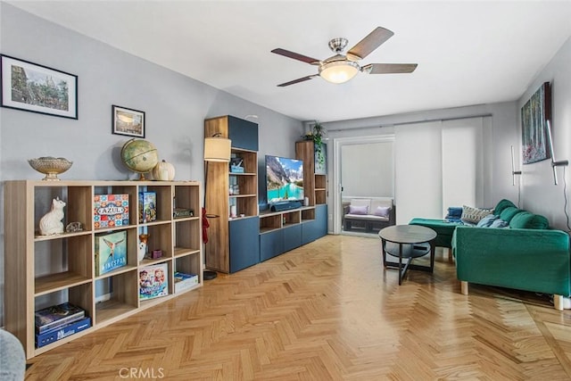 living area with light parquet floors and ceiling fan