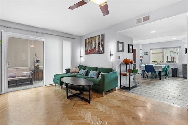 living room with ceiling fan and light parquet floors