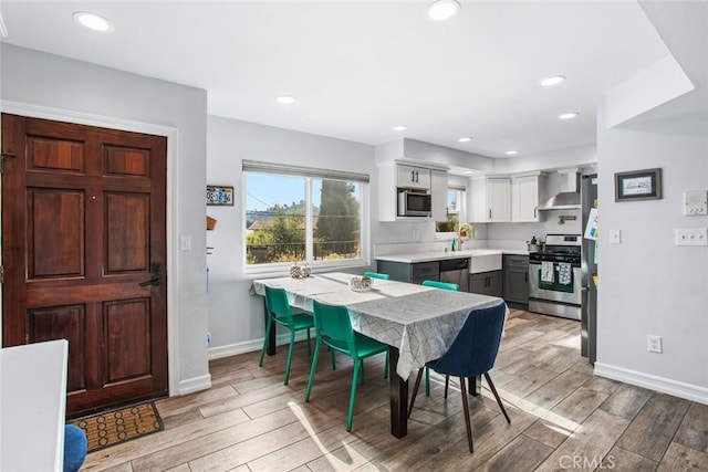 dining room with light hardwood / wood-style floors and sink