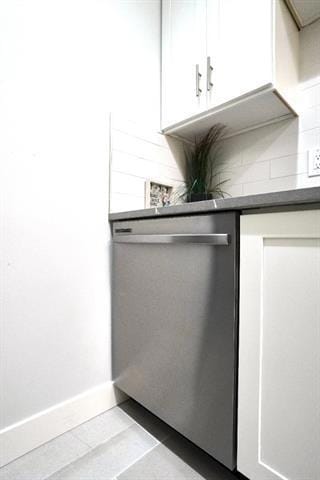 room details featuring tasteful backsplash and stainless steel dishwasher