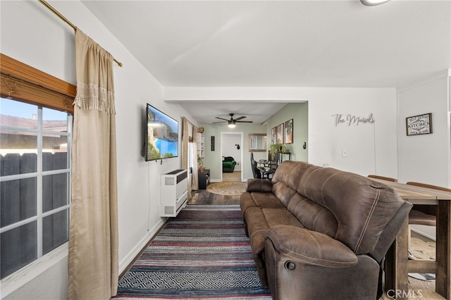 living room featuring heating unit, ceiling fan, and hardwood / wood-style floors