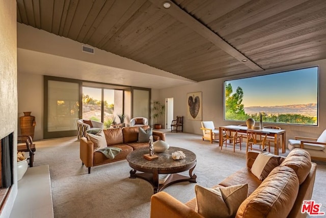 living room with a healthy amount of sunlight, lofted ceiling, a fireplace, and wood ceiling