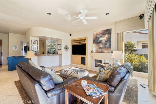 tiled living room with ceiling fan