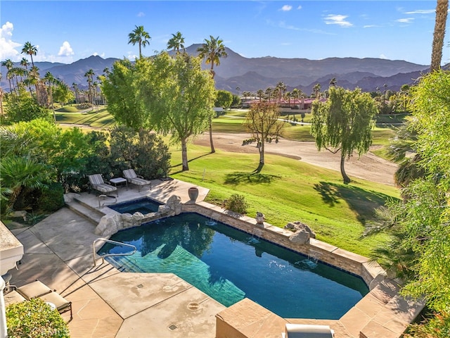 view of swimming pool featuring an in ground hot tub, a mountain view, a patio, and a lawn