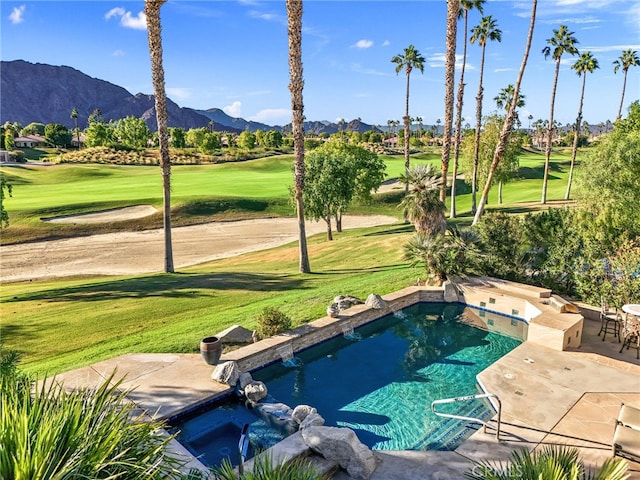 view of swimming pool with a patio, a mountain view, and a yard