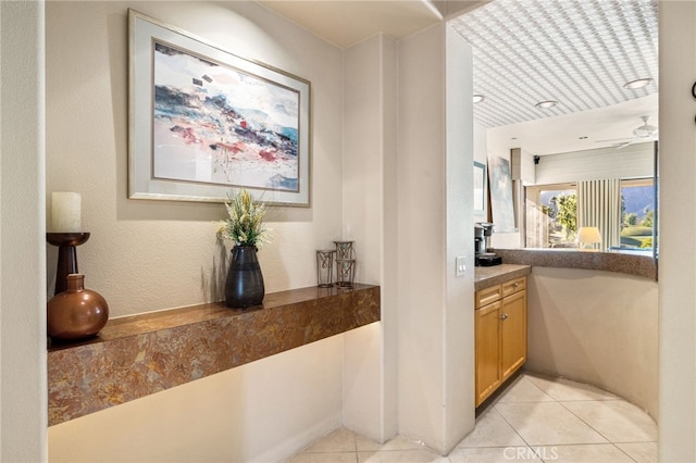 hall featuring light tile patterned floors