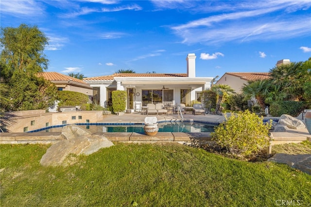 rear view of house with a yard, a patio, and ceiling fan