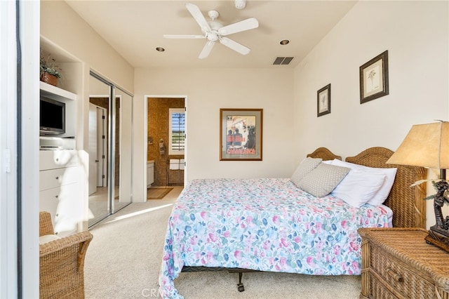 carpeted bedroom with ceiling fan and a closet