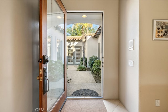 doorway featuring light tile patterned floors