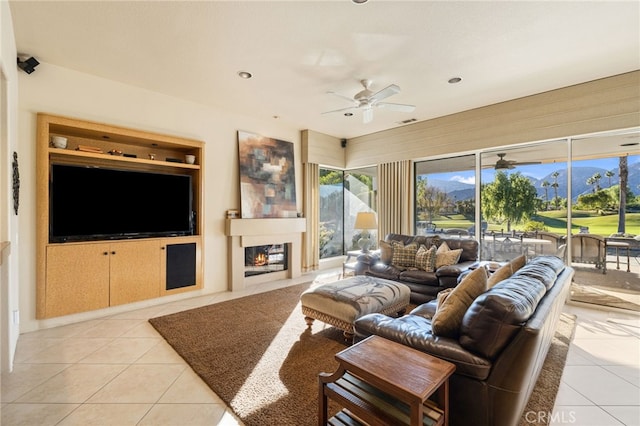 tiled living room featuring a mountain view and ceiling fan