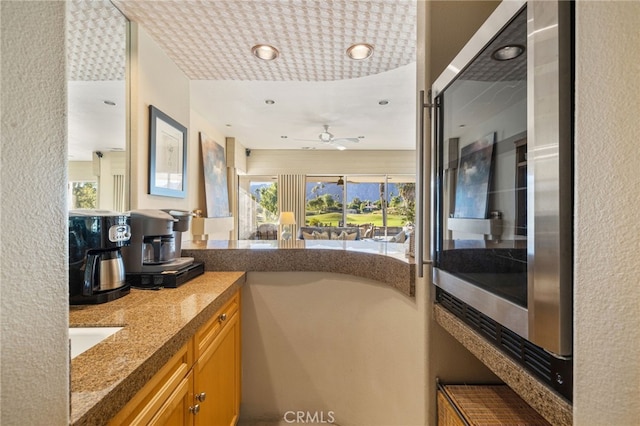 bathroom with ceiling fan and vanity