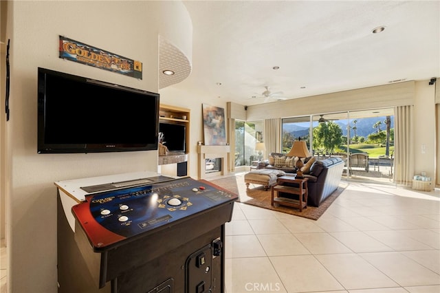 playroom with light tile patterned floors and ceiling fan