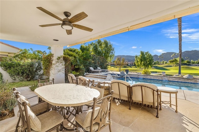 view of patio featuring ceiling fan and a mountain view