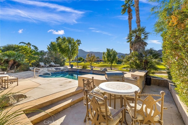 view of pool featuring a mountain view and a patio area