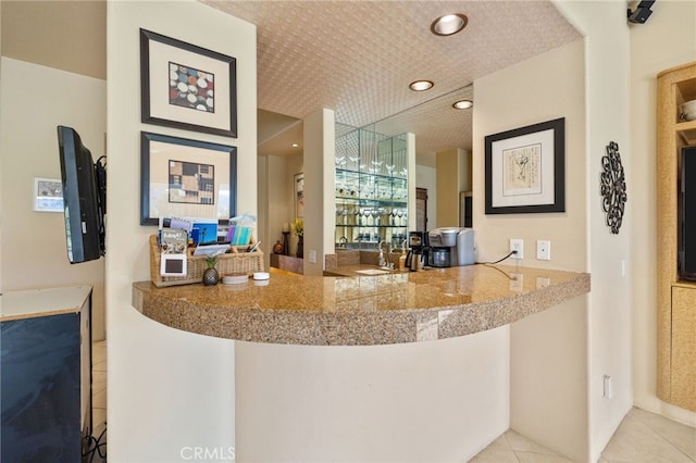 bar with light tile patterned floors and sink