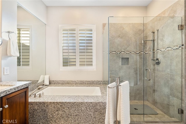 bathroom featuring vanity and separate shower and tub