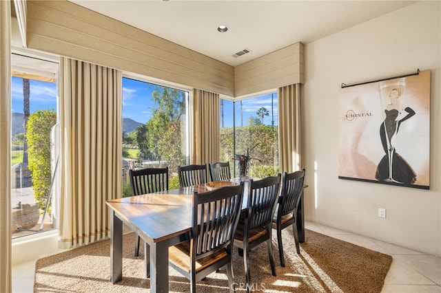 tiled dining room featuring a mountain view and plenty of natural light