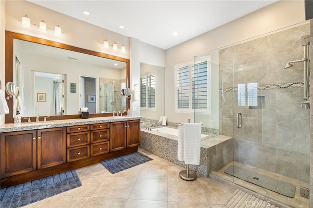 bathroom featuring vanity, tile patterned flooring, and shower with separate bathtub