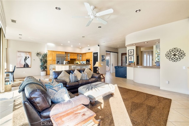 living room featuring light tile patterned flooring and ceiling fan