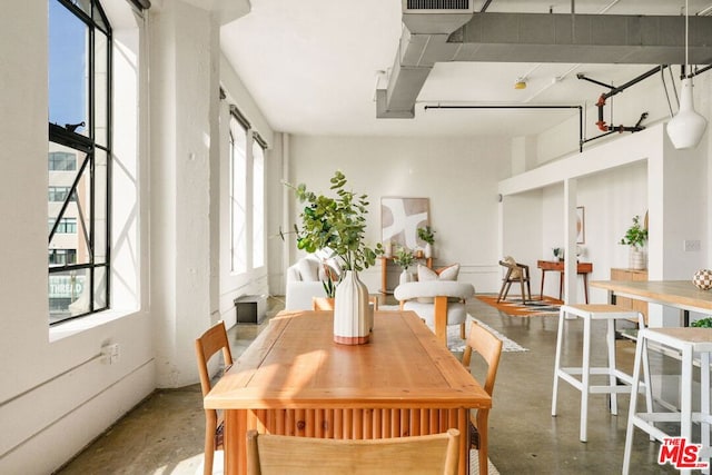 dining room with concrete floors and plenty of natural light