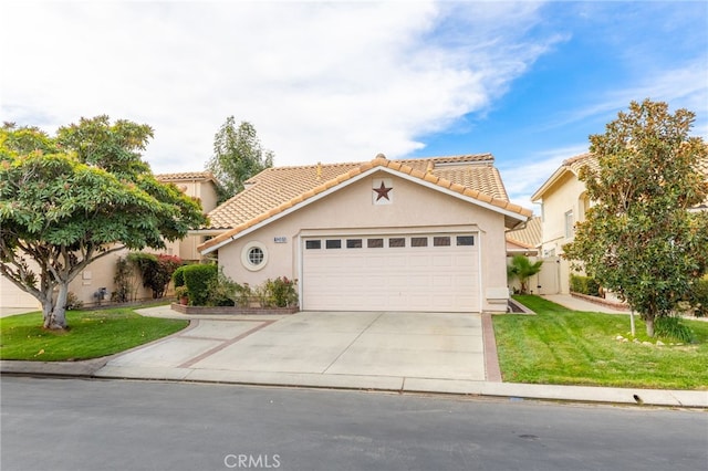 view of front of property featuring a garage and a front lawn