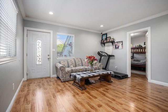 foyer with crown molding and light wood-type flooring