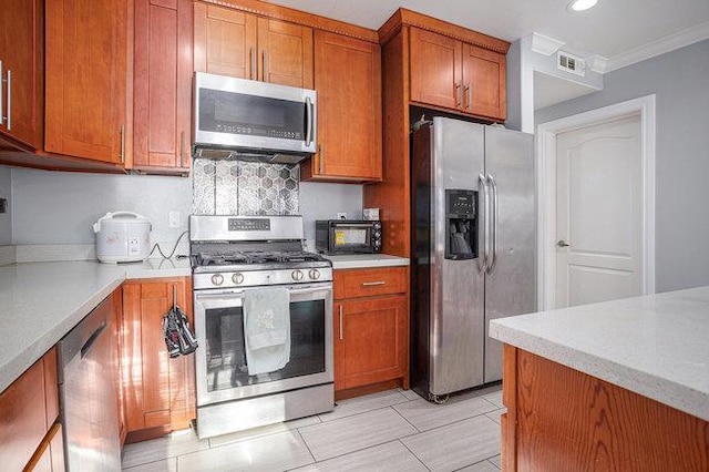 kitchen with backsplash, ornamental molding, and stainless steel appliances