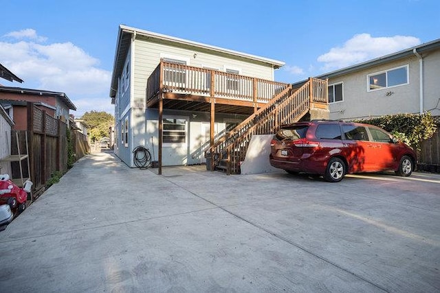 rear view of house featuring a wooden deck