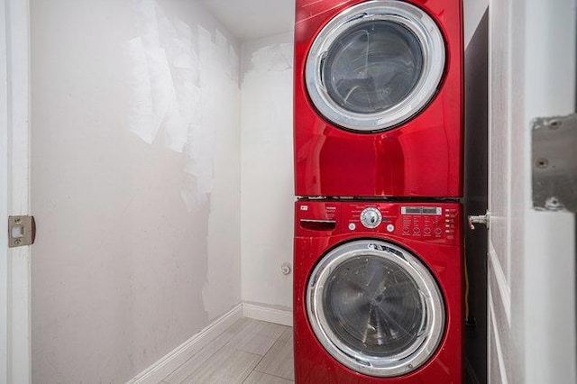 washroom featuring stacked washing maching and dryer