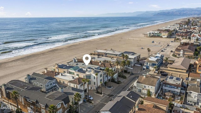 aerial view featuring a water view and a beach view