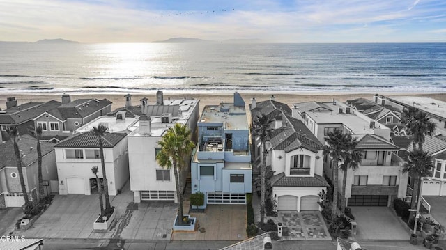 drone / aerial view with a beach view and a water view