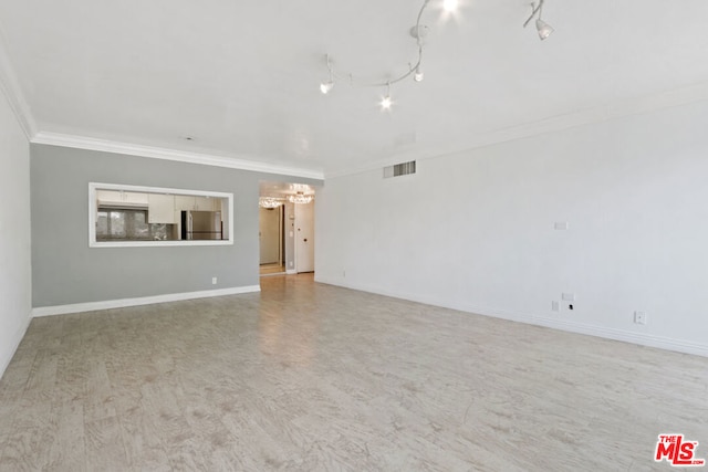 unfurnished living room featuring crown molding, track lighting, and light wood-type flooring