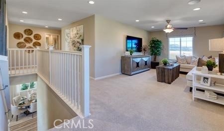 living room featuring ceiling fan and light colored carpet