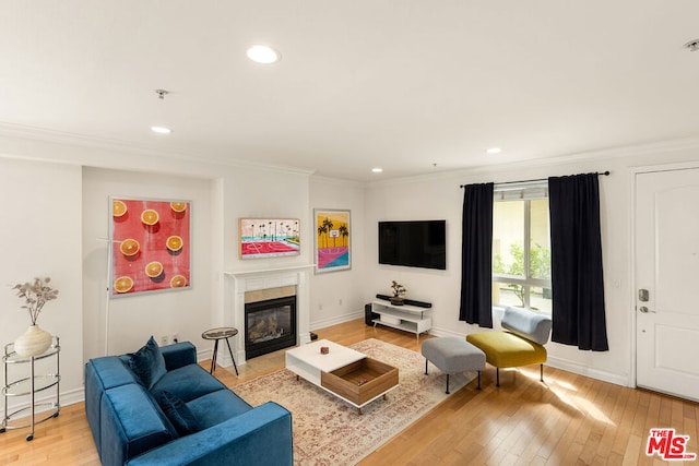 living room featuring light hardwood / wood-style flooring and ornamental molding