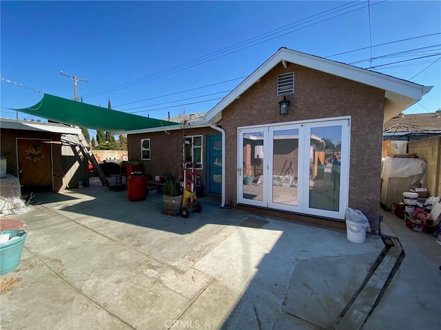 back of house featuring french doors and a patio