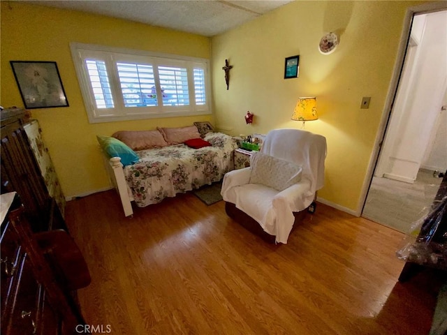 bedroom with hardwood / wood-style floors