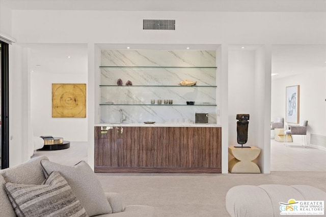 bar featuring light colored carpet and built in features