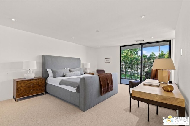 bedroom featuring light carpet and floor to ceiling windows