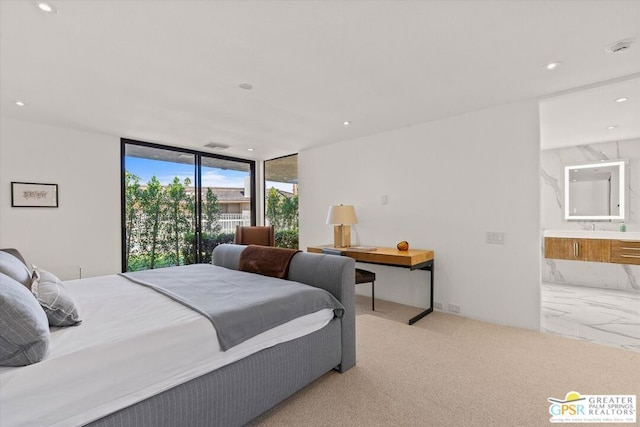 bedroom featuring connected bathroom, light colored carpet, floor to ceiling windows, and access to exterior