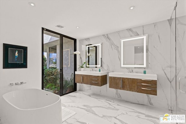 bathroom with floor to ceiling windows, vanity, and a tub to relax in