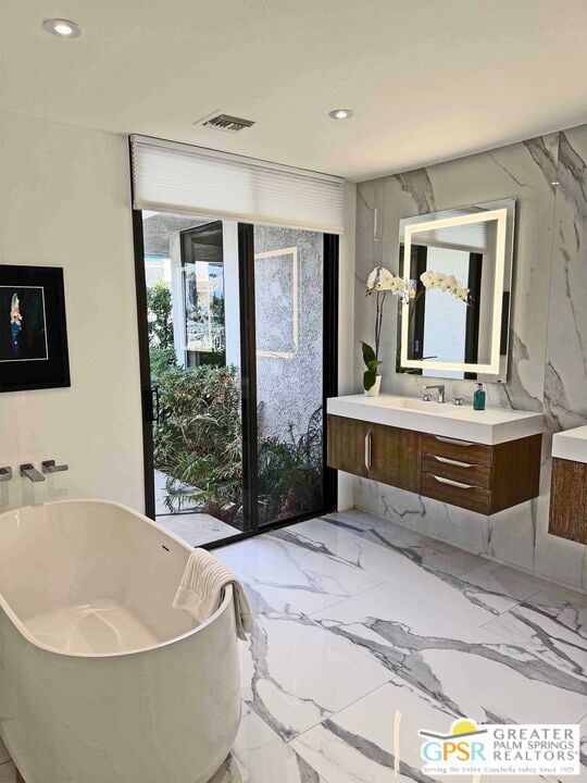 bathroom with vanity and a bathtub